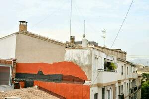 a view of a building with a red wall photo