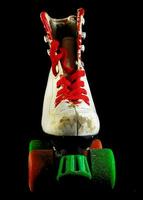 a pair of roller skates with green and red laces photo