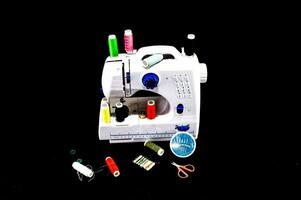 a sewing machine with various threads and needles photo
