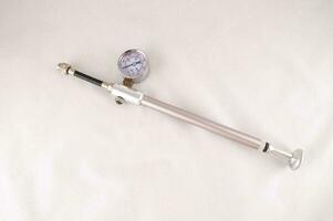 a metal rod with a gauge and a hose photo