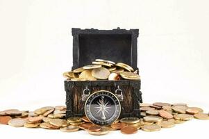 a wooden chest with coins and a compass photo