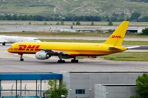 DHL cargo plane at airport. Air freight and shipping. Aviation and aircraft. Transport industry. Global international transportation. Fly and flying. photo