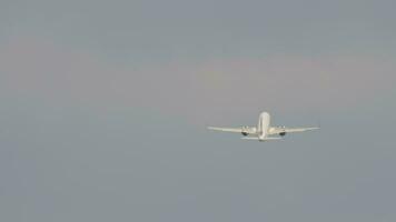 Aircraft climbing. Jet passenger plane flies away, long shot. Rear view of an airliner take off, leaving video