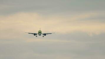 Jet plane approaching landing. Aircraft landing gear release. Slow motion, airliner flying, front view video