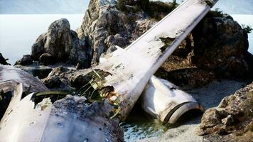 Plane wreck on the beach with rocks near ocean video