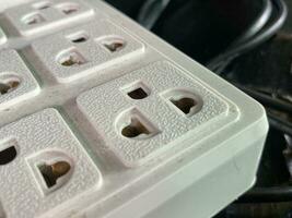 close - up of a black and white photo of a white and brown plastic box with a white plug