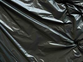 black crumpled black plastic bag photo