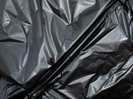 black crumpled black plastic bag photo