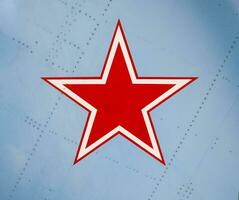 Five-pointed red star on the wing skin of a military fighter photo