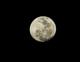 a full moon is seen in the dark sky photo