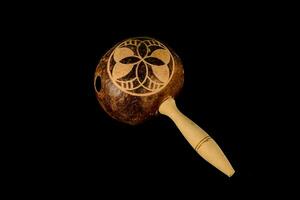 a wooden maracas with a design on it photo