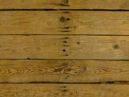a close up of a wooden wall with some holes photo