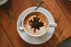 Italian style coffee with milk with drawing of the Canadian flag photo