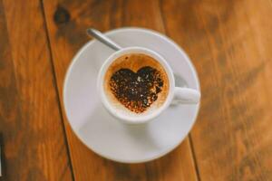 Italian style coffee with milk with a drawing of a heart. photo