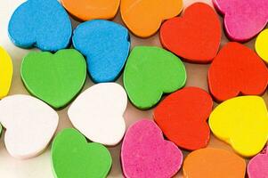 a pile of colorful wooden hearts photo