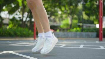 Close-up of a woman in sports clothes running in place and warming up before a morning run. video