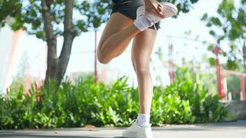 Woman trains her thigh muscles while running on the field. video