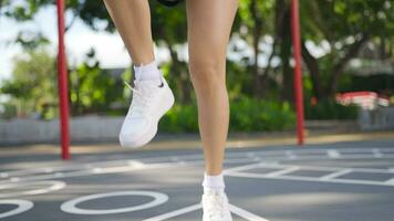 Close-up of a woman in sports clothes running in place and warming up before a morning run. video