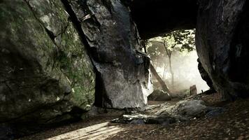 Shaft of light beaming down into large cave video