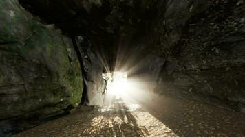 Shaft of light beaming down into large cave video