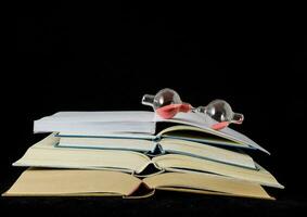 a stack of books with an hourglass on top photo