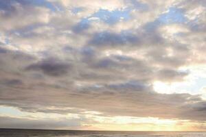 view of a cloudy sky and the ocean photo