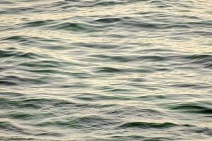 the ocean is seen from above with small waves photo