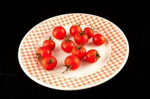 a plate with a checkered pattern has tomatoes on it photo