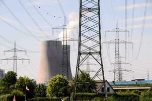 power lines and a nuclear power plant in the background photo