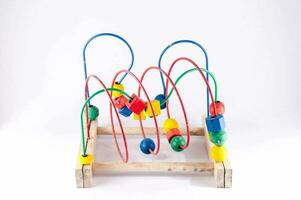 a wooden toy with colorful beads on it photo