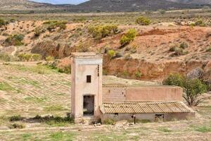 an old building in the middle of nowhere photo