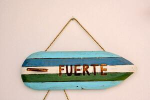 a wooden sign with the word fuerte on it photo