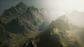 A breathtaking aerial view of majestic sunlit mountain peaks video