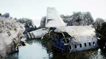 Plane wreck on the beach with rocks near ocean video