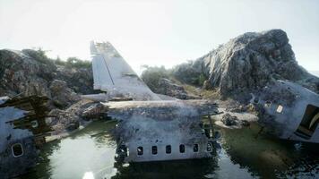 Destroyed aircraft on rugged island coast video