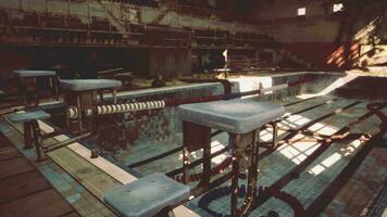 An abandoned swimming pool with empty benches and tables video