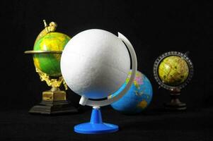 a globe on a stand with other globes photo
