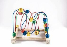 a wooden toy with colorful beads on it photo