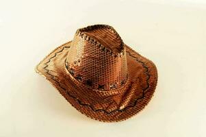 a brown cowboy hat on a white surface photo