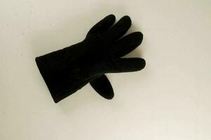 un negro guante en un blanco superficie foto