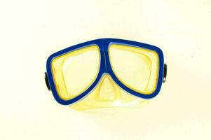 a yellow and blue diving mask on a white background photo