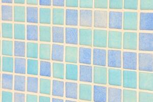 a tile wall with a blue square pattern photo