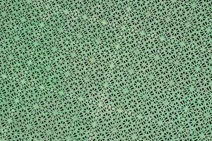 a green background with a pattern of holes photo