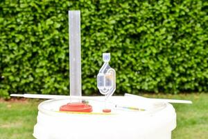 a white bucket with a plastic funnel and a plastic tube photo