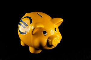 a yellow piggy bank with a blue logo photo