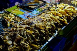 a variety of food is being sold on a street photo