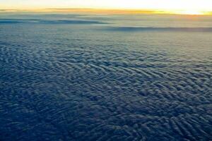 the view from an airplane window at sunset photo