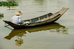 a man in a boat on the water photo