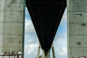 a bridge with a large concrete structure under it photo