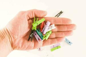 a hand holding a bunch of small clothes pins photo